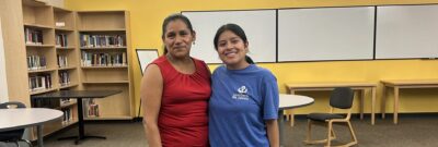 Semillero staff member standing with a farmworker innovator